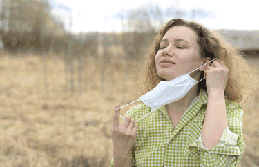 girl putting on a mask