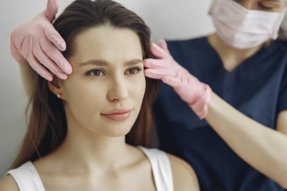 Woman with a doctor in cosmetology studio